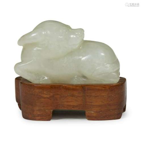A small Chinese carved white jade recumbent water
