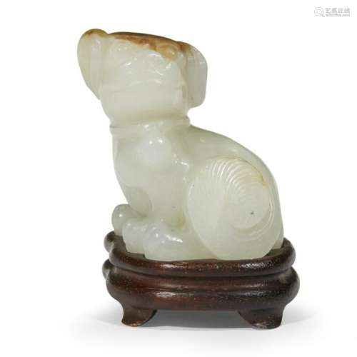 A small Chinese white and russet jade carving of a dog