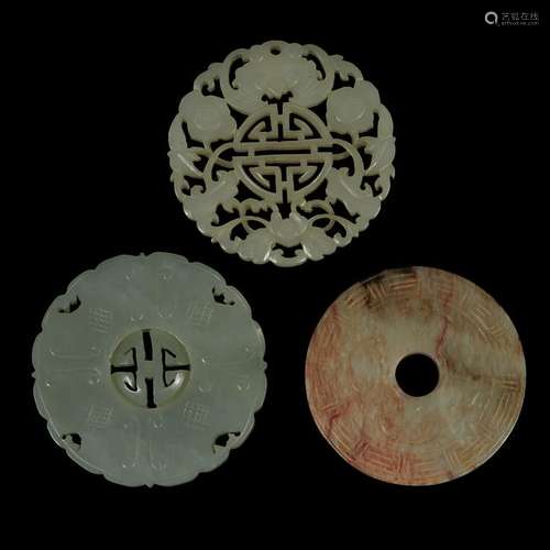 Three Chinese carved jade circular plaques qing