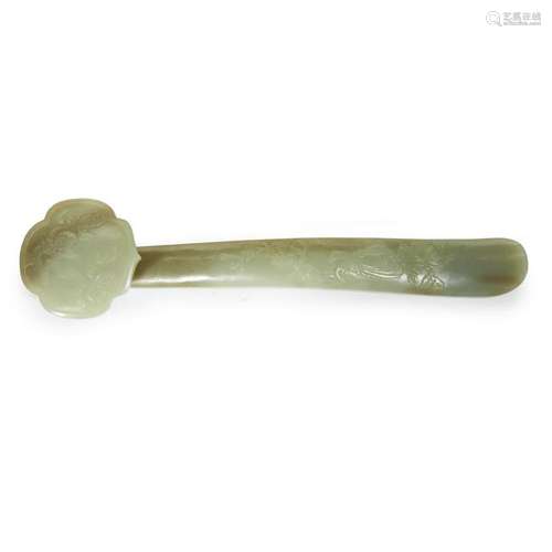 A Chinese celadon jade ruyi scepter. The head carved in