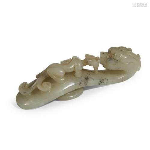 A carved celadon jade belt hook qing dynasty, 18th/19th