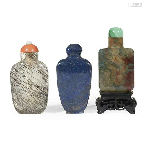 Three Chinese carved hardstone snuff bottles. The