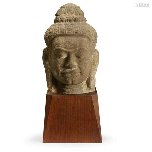 A Khmer style carved beige sandstone head of a