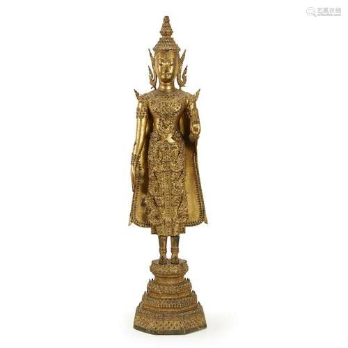 A Thai mirror-embellished gilt-lacquered figure of