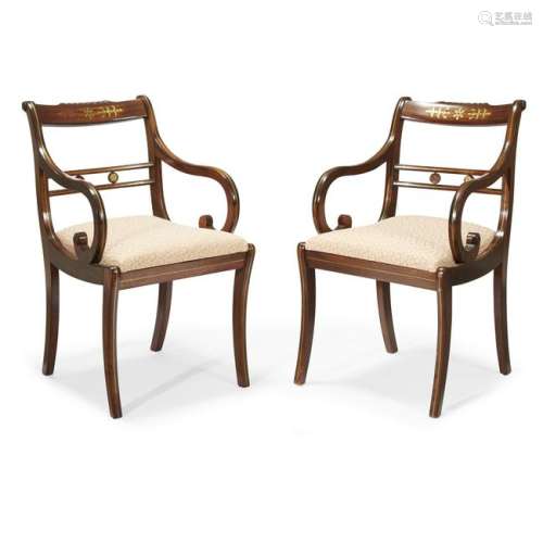 A pair of Regency brass-inlaid mahogany armchairs first