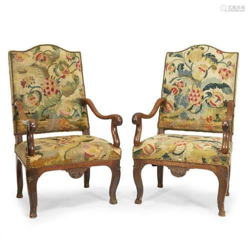 A pair of Louis XIV/RÃ©gence carved walnut fauteuils Ã