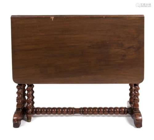 A Jacobean Style Mahogany Drop Leaf Trestle Table