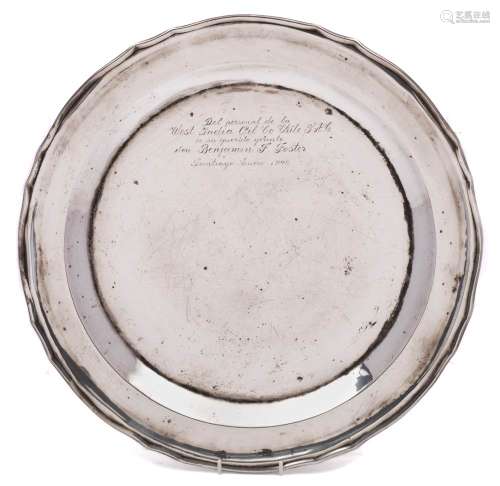 A large South American silver charger, stamped Chile, 900: inscribed, with a wavy-edge border, 45cm.