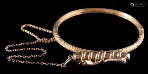 A hinged bangle with attached propelling pencil: the plain polished propelling pencil within a