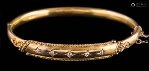 A late 19th century 15ct gold and diamond hinged bangle: with five square-set round old