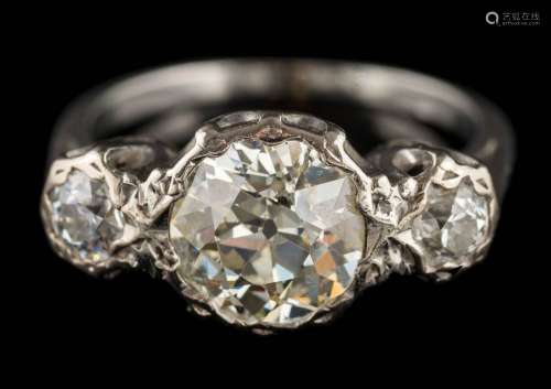 An illusion-set diamond three-stone ring: the principal round old-cut diamond approximately 8.