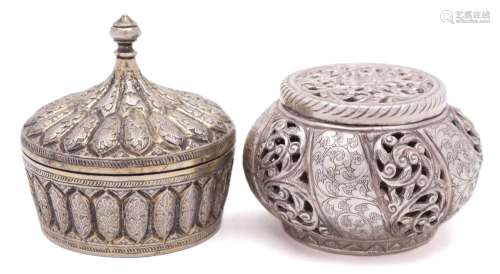 An Indian white metal circular box and cover: with knopped spire-shaped finial and lobed foliate