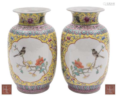 A pair of Chinese famille rose vases: each painted with two lotus panels of birds perched on