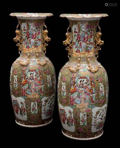 A pair of large Canton famille rose enamel baluster vases: with gilt double lion dog handles and