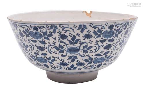 A large English blue and white delftware bowl: the exterior painted with stylised floral sprays and