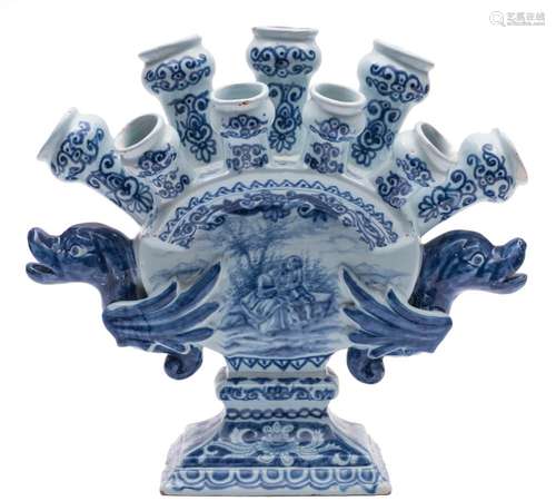 A Dutch blue and white delftware tulip vase: the body of arched flattened form with nine nozzles in