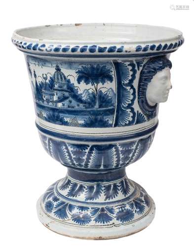 An impressive large French faience jardiniere: of campana form with female mask head handles,