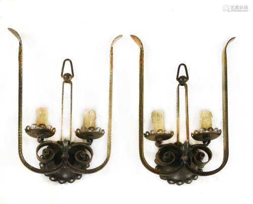 A pair of French iron twin-branch wall lights,