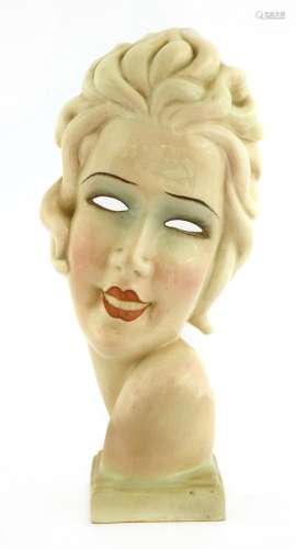 An Art Deco pottery mask of a girl,