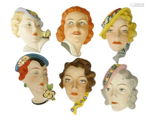 Six Art Deco Czechoslovakian pottery wall masks,