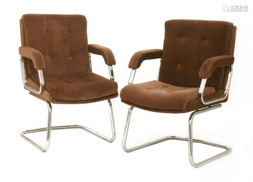 A pair of tubular chrome armchairs,