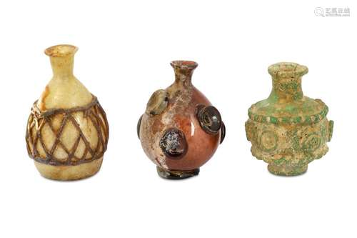 THREE UMAYYAD HOT-WORKED GLASS BOTTLES