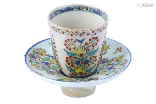 A KUTAHYA POTTERY COFFEE CUP WITH HOLDER