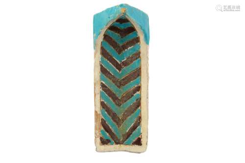 A TURQUOISE AND BROWN-PAINTED CUERDA SECA POTTERY NICHE TILE (MUQARNAS)