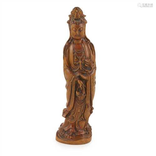CARVED BOXWOOD FIGURE OF GUANYIN QING DYNASTY, 19TH CENTURY depicted in flowing robes holding a