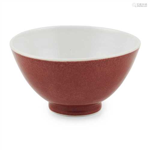 RED GLAZE DEEP BOWL 20TH CENTURY of plain form, the outer body decorated in a slightly mottled red
