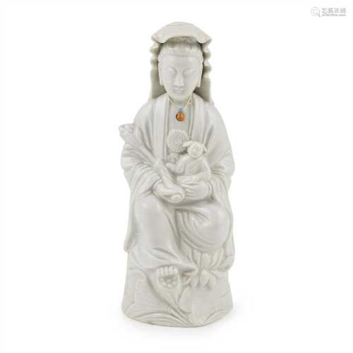 DEHUA FIGURE OF GUANYIN QING DYNASTY, 18TH-19TH CENTURY depicted holding a child and lotus flower,