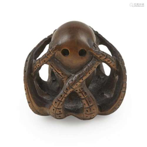 CARVED SOFTWOOD NETSUKE OF A OCTOPUS MEIJI PERIOD worked as an octopus with up curled tentacles,