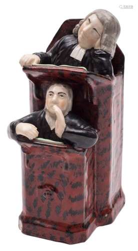 A late Staffordshire pottery 'Vicar and Moses' group: the parson dozing in the pulpit,