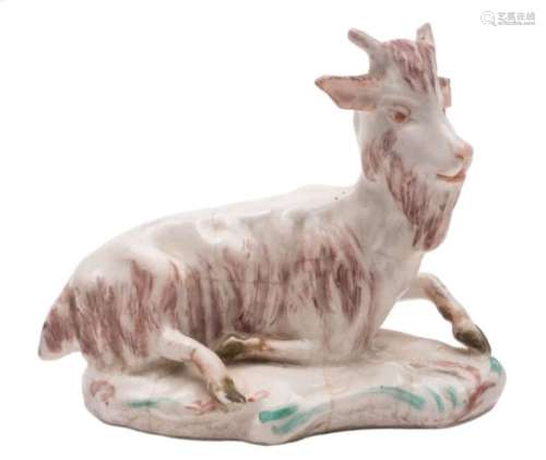 A Torquay porcelain model of a recumbent goat in 18th century Derby style: on scrollwork mound base,