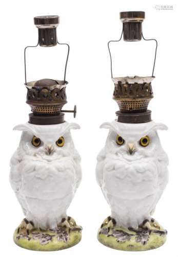 Two French porcelain owl table lamps: with glass eyes and white plumage, on mound bases,
