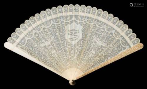 A Cantonese carved ivory brise fan: carved to one side with central shield-shaped cartouche flanked