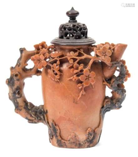 A Chinese soapstone wine pot: carved with flowering prunus and rockwork,15 cm and wood cover.