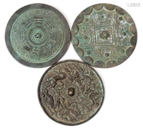 A Chinese bronze mirror: of archaic circular form decorated with mythical animals, 13cm.