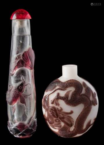 Two Chinese overlay glass snuff bottles: the first in aubergine and opaque glass and carved with a