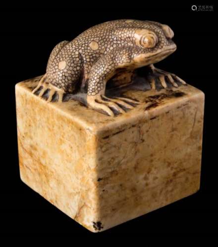 A Chinese carved soapstone seal: of sandy brown colour and square form topped with a toad,