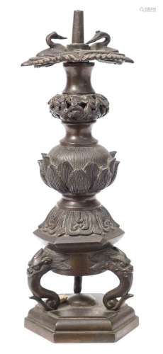 A Japanese bronze candle holder: of stupa form with lotus flower and pierced foliate knops,