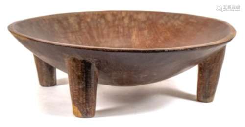 A Fijian Yaqona bowl: the plain circular bowl raised on four tapering legs,