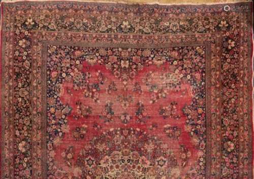 An Iranian carpet,: the wine field with a central arabesque floral medallion,