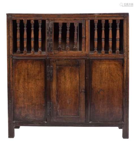 A French oak fruit hutch: with spindle inset doors above cupboard doors below,