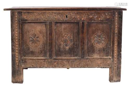 A 17th century carved oak rectangular coffer: with a plain hinged top,