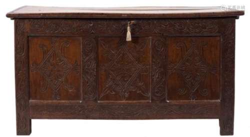 An 18th Century carved oak rectangular coffer:, the plain hinged top with a channel moulded edge,