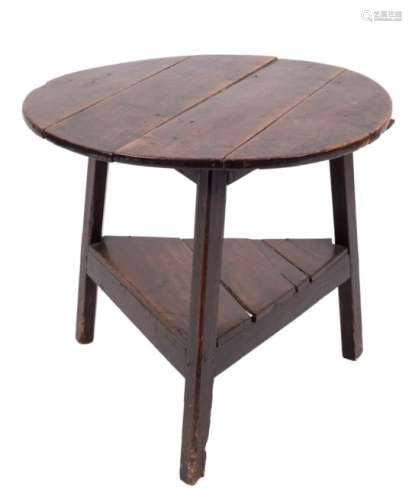 An early 19th Century elm and fruitwood circular cricket table:, on triangular splayed legs,