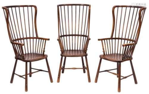 A set of three ash, fruitwood and beech stick back Windsor wing armchairs:, with curved backs,