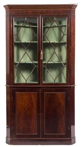 A 19th century mahogany standing corner display cabinet,: the upper part with a moulded cornice,