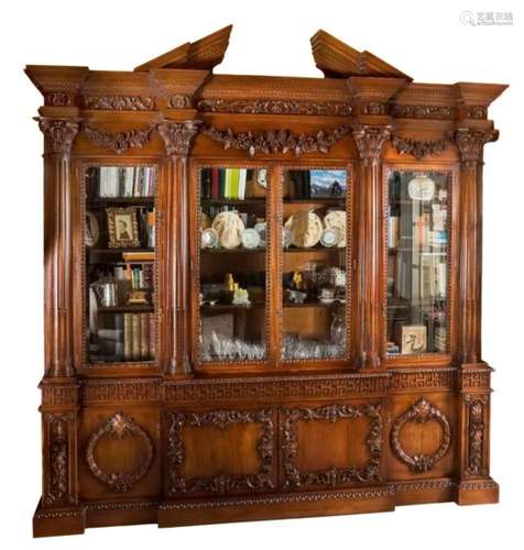 An 18th Century style carved mahogany breakfront library bookcase after the original by William